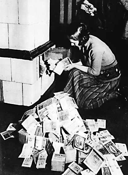 woman burning paper money for heat